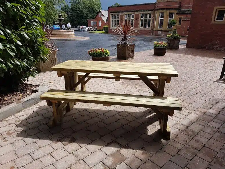 a frame picnic bench in front of a hotel