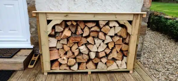 The Coppice log store with logs in garden