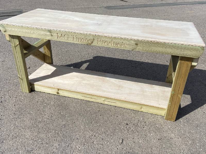 a frame wooden picnic table at a public farm