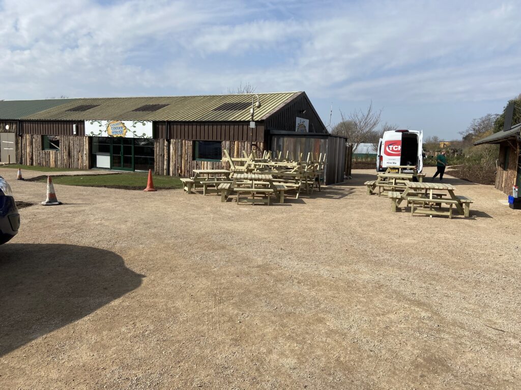 Wooden picnic tables stacked in front of Twycross Zoo picnic area
