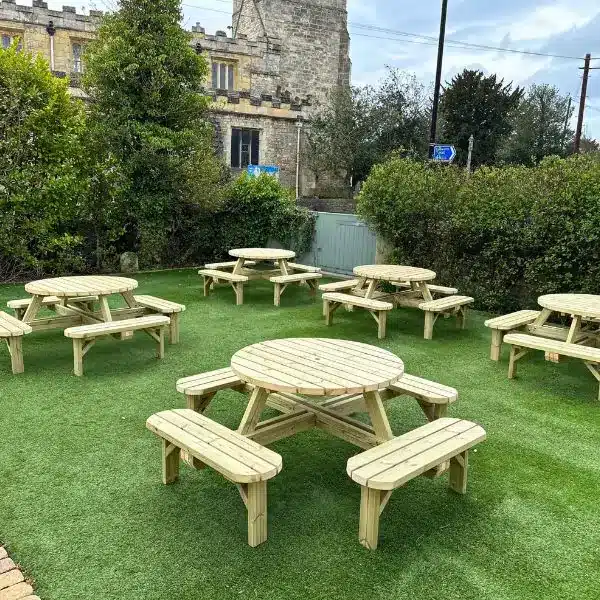 wooden picnic tables in a pub setting
